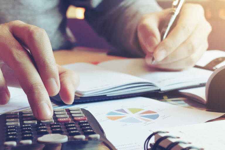 Close up hand man doing finance and calculate on desk about cost